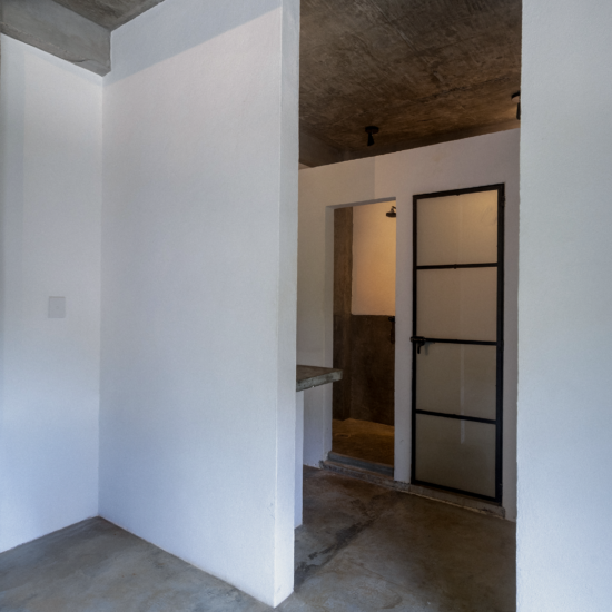 Private bathroom entrance and walk-in shower in Soirée’s King Bedroom